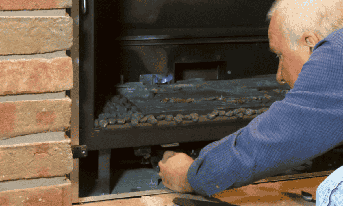 Technician servicing the controls of a gas fireplace